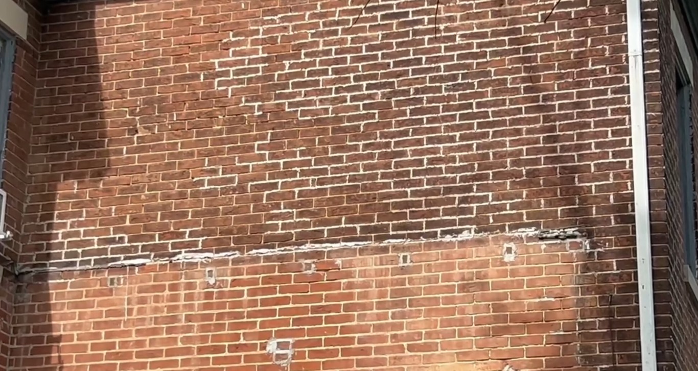 Professional masonry contractors working on brick repair in Rochester, MN